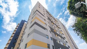 A multi-story building with a modern architectural design, featuring a mix of balconies and windows. - Cozy Studio in Sao Paulo Sp-a713 (Sao Caetano do Sul)