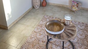 A modern kitchen with wooden cabinets, a countertop, and a dining area with a round table and chairs.