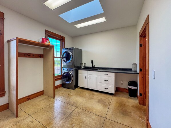 Laundry room with washer, dryer, and utility sink.