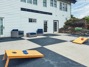 Patio with cornhole and outdoor seating.