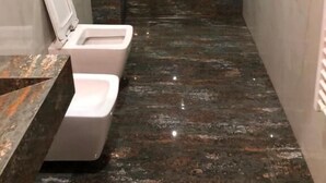 A small, modern bathroom with a shower, a toilet, and a vanity with a marble countertop. - Tirent Apartment Komuna Parisit 1 (Tirana)