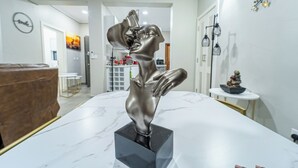 Une table en marbre surmontée d’une sculpture en bronze représentant une figure humaine.