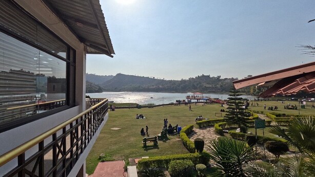 A view of a lakeside park with a gazebo, benches, and a well-maintained lawn. - Tikkar Taal Morni Hills (Panchkula)