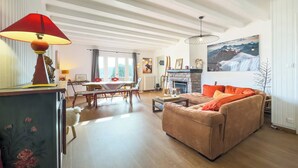 A living room with a sofa, a table, and a fireplace.