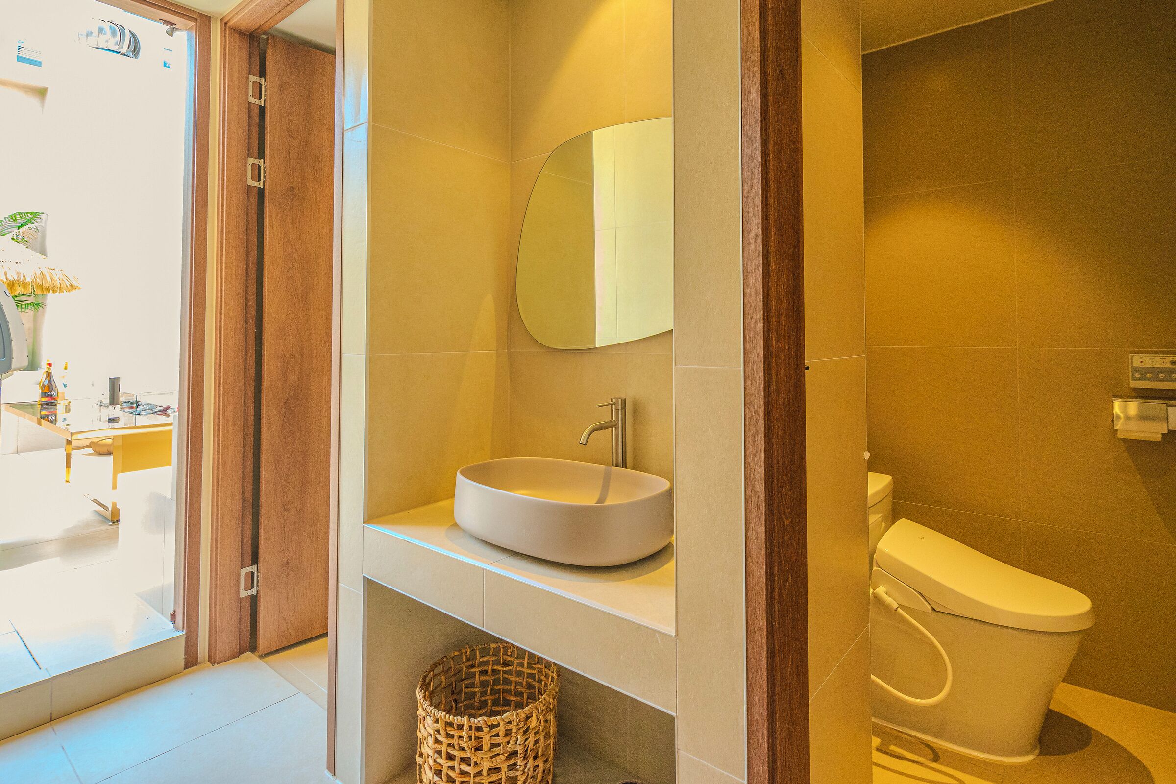 A bathroom with a white sink, a mirror, and a toilet.