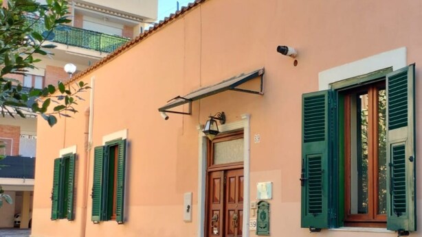 A building with green shutters, a door, and a small balcony. - "Enchanted Home" Independent and close to the center of Civitavecchia- Rome (Civitavecchia)