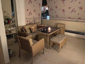 Relax in this inviting outdoor seating area with a sofa, armchairs, and a small table.