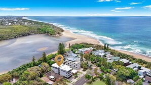 An aerial view of a coastal area with a beach, ocean, and residential buildings. - Hume Parade 19, Unit 1, Currimundi (Currimundi)
