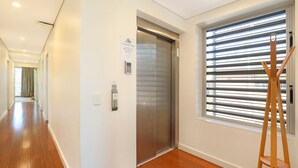 A modern elevator with a control panel and a sign with instructions. - Hume Parade 19, Unit 1, Currimundi (Currimundi)