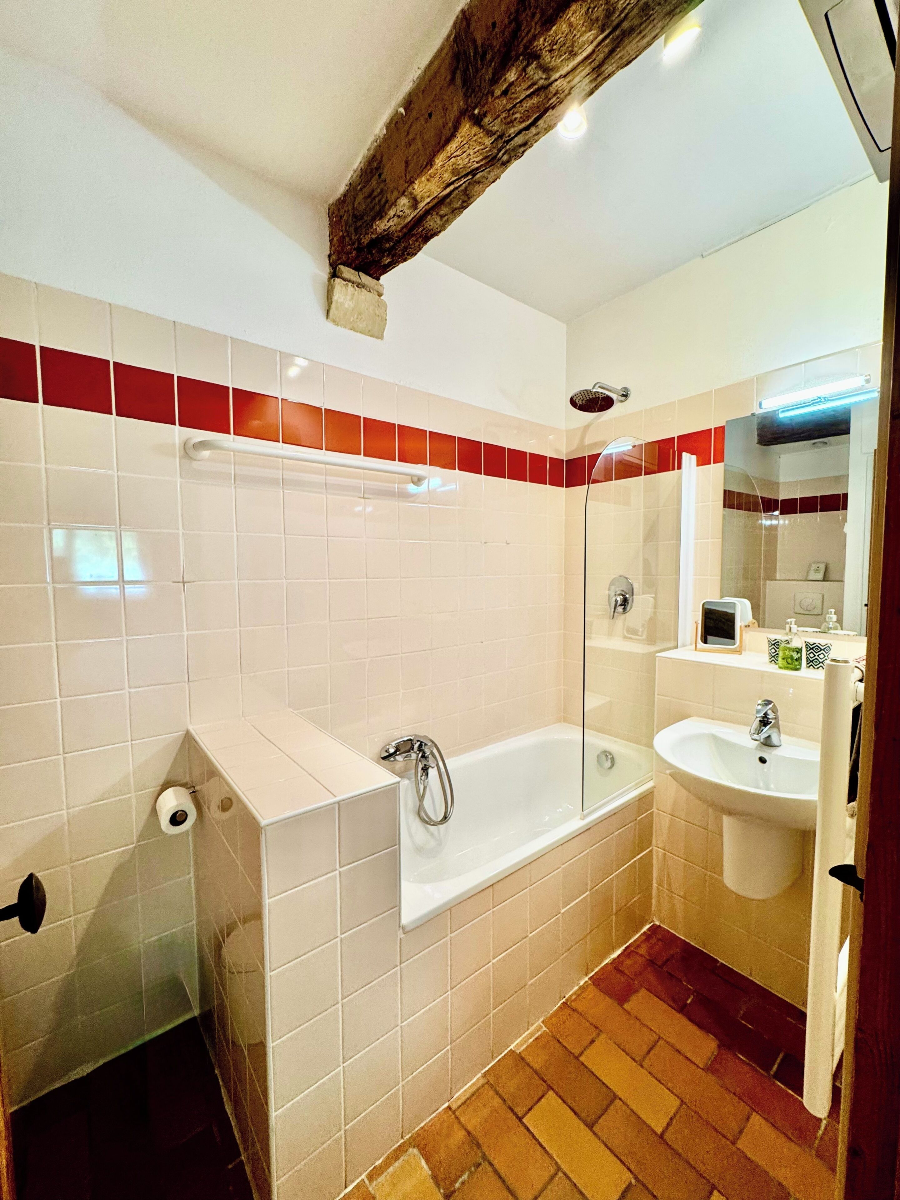 A bathroom with a bathtub, a sink, and a shower.