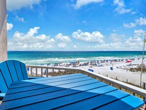 A beach view from a balcony with blue chairs and a railing. - Beachfront Remodeled 2025 🦀🦀 Crystal Dunes' Best 😎😎 CHECKOUT THIS REMODEL🩴🩴🩴 (Destin)