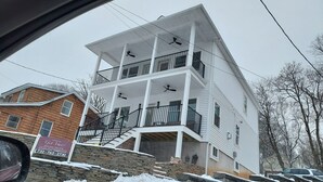 A multi-story building with balconies, a stone retaining wall, and a stone staircase. - Tranquil lakefront oasis - close to NYC and NJ attractions (Watchung)