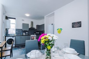 Enjoy meals in the kitchen and dining area, featuring an oven and table for four.