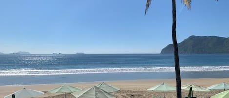 On the beach, sun-loungers