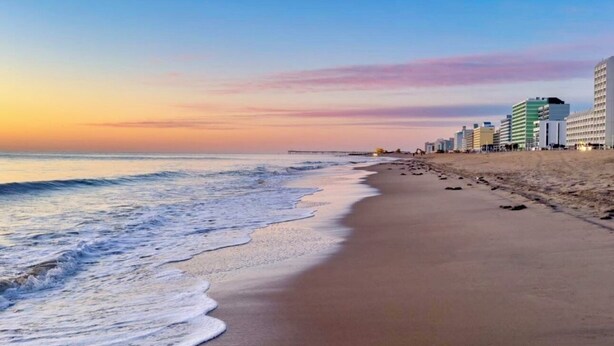 A beach with a row of buildings along the shore. - North End Villa-behind the Cavalier2blocks2 beach (Virginia Beach)