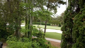 A golf course with a sand bunker, surrounded by dense trees and a walking path. - North End Villa-behind the Cavalier2blocks2 beach (Virginia Beach)