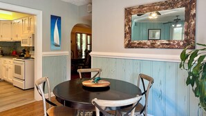 A dining area with a round table, chairs, and a decorative mirror on the wall. - North End Villa-behind the Cavalier2blocks2 beach (Virginia Beach)