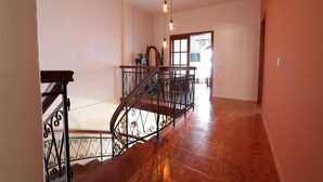 A staircase with ornate metal railings and a polished wooden handrail. - House Sea View with Communal Pool (Corfu)