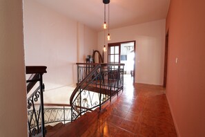 A staircase with ornate metal railings and a polished wooden handrail.
