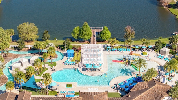 Ein Resort mit mehreren Schwimmbecken, einer Wasserrutsche und Liegebereichen.