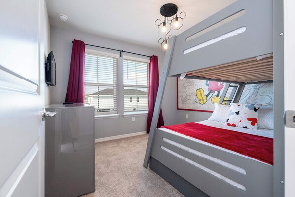 A bedroom with a bunk bed, a small fridge, a window with blinds, and a ceiling light fixture. - Luxury Private Pool & Themed Rooms Close To Disney 1282 (Clermont)