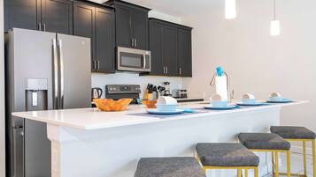 Superior Townhome | Private kitchen | Full-size fridge, microwave, oven, stovetop