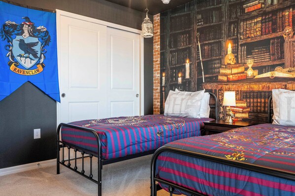 A bedroom with two beds, a bookshelf, and a Ravenclaw banner. - Stunning 7Bd Jacuzzi Pool & Close To Disney @ Windsor Cay 16217 (Clermont)