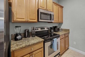 Superior Townhome | Private kitchen | Full-size fridge, microwave, oven, stovetop
