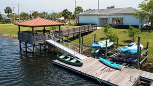 A dock with kayaks, a covered seating area, and a small building. - Wonderful 4Bd With Pool At Storey Lake Resort 4819 (Kissimmee)