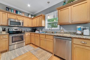Enjoy cooking in this well-equipped kitchen with a large window and modern appliances.