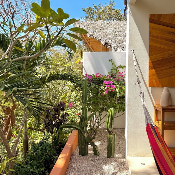 A garden with various plants and a hammock. - A natural setting in Playa Grande, peaceful and relaxing place! (Playa Grande)