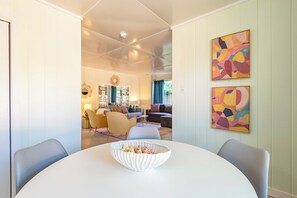 A dining area with a round table, chairs, and a decorative bowl.