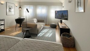 A modern living room with a sofa, a coffee table, a TV, and a dining area with a table and chairs. - Studio.Ø5 City View (Porto)