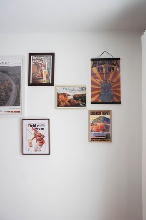 A wall with six framed posters. - Hunter House (Livingston Manor)