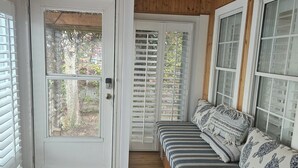 A wooden-paneled room with a bench, a door, and windows. - Oceanside Village Beautiful 3BR 3BA - Golf Cart Included! (Surfside Beach)