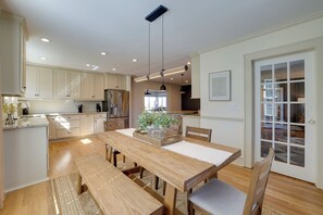 Enjoy meals in the kitchen with an oven and stainless steel appliances, then dine at the wooden table with benches.