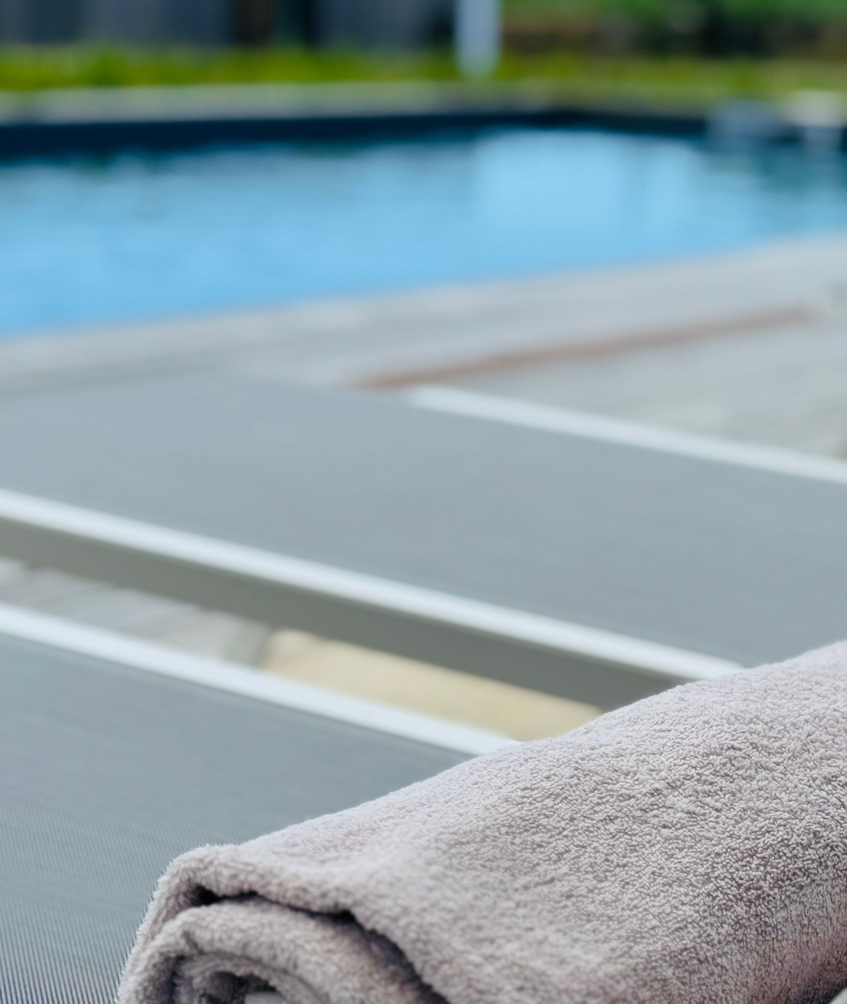 A towel on a chair near a pool.