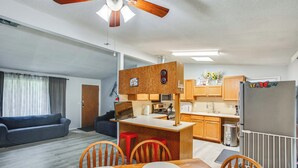 A compact living space with a kitchenette, dining area, and a sofa in a living room. - 6 Mi to Lake Meridian Park: Auburn Home w/ Yard (Auburn)
