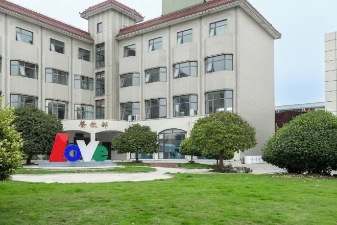 A multi-story building with a large entrance and a sign that reads 'Love.'
