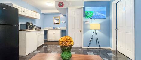 Fridge, microwave, coffee/tea maker, cookware/dishes/utensils