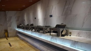 A modern reception area with marble walls and a long reception desk. - Lanzuan Hotel (Ankang)