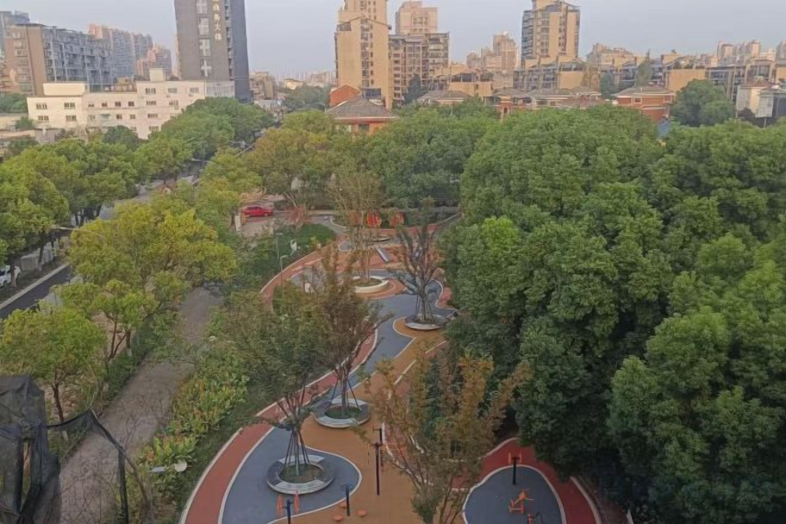 A park with pathways, trees, and a playground.