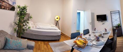 Design Apartment, 2 Bedrooms | Living area | 35-inch Smart TV with digital channels