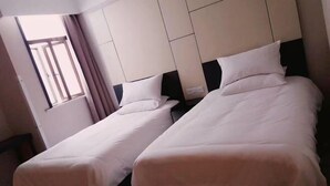 A hotel room with two single beds, a window with curtains, and a headboard with a panel design. - UMYouXuan Gaoxing Hotel (Shanghai Lianhua South Road) (Shanghai)