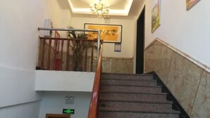 A staircase with a wooden handrail leading to an upper floor. - UMYouXuan Gaoxing Hotel (Shanghai Lianhua South Road) (Shanghai)
