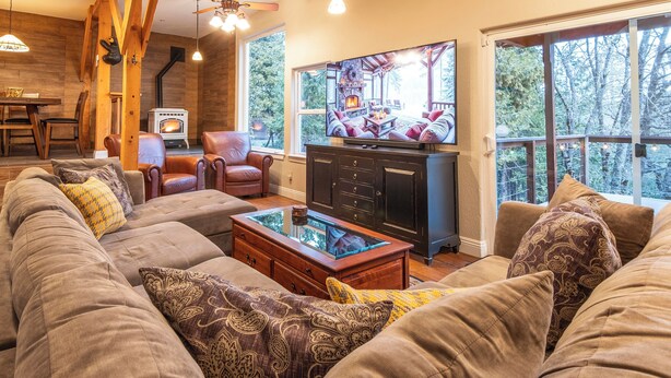 A cozy living room with a sofa, a coffee table, and a fireplace.