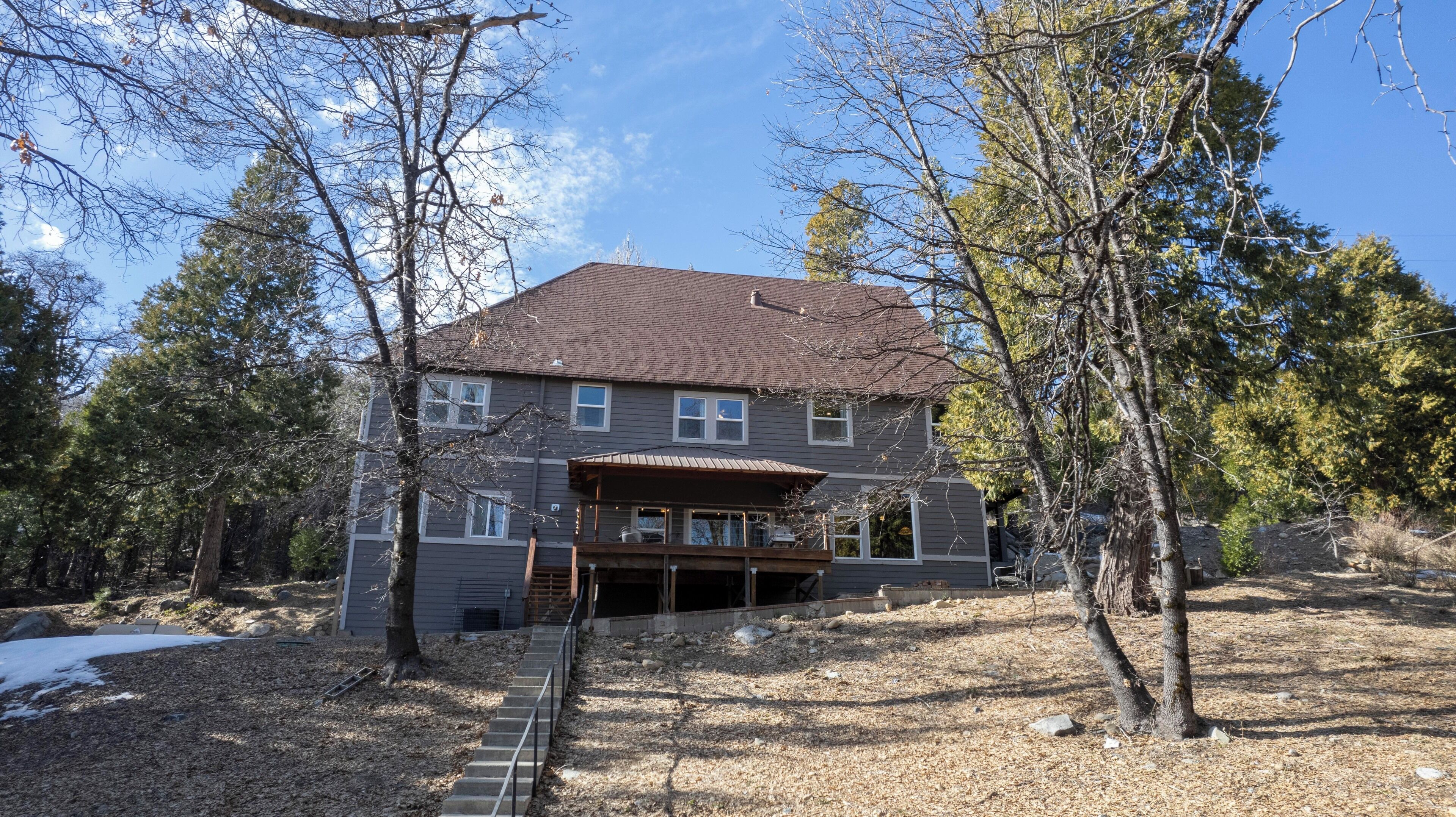 A two-story house with a covered front porch and a garage.