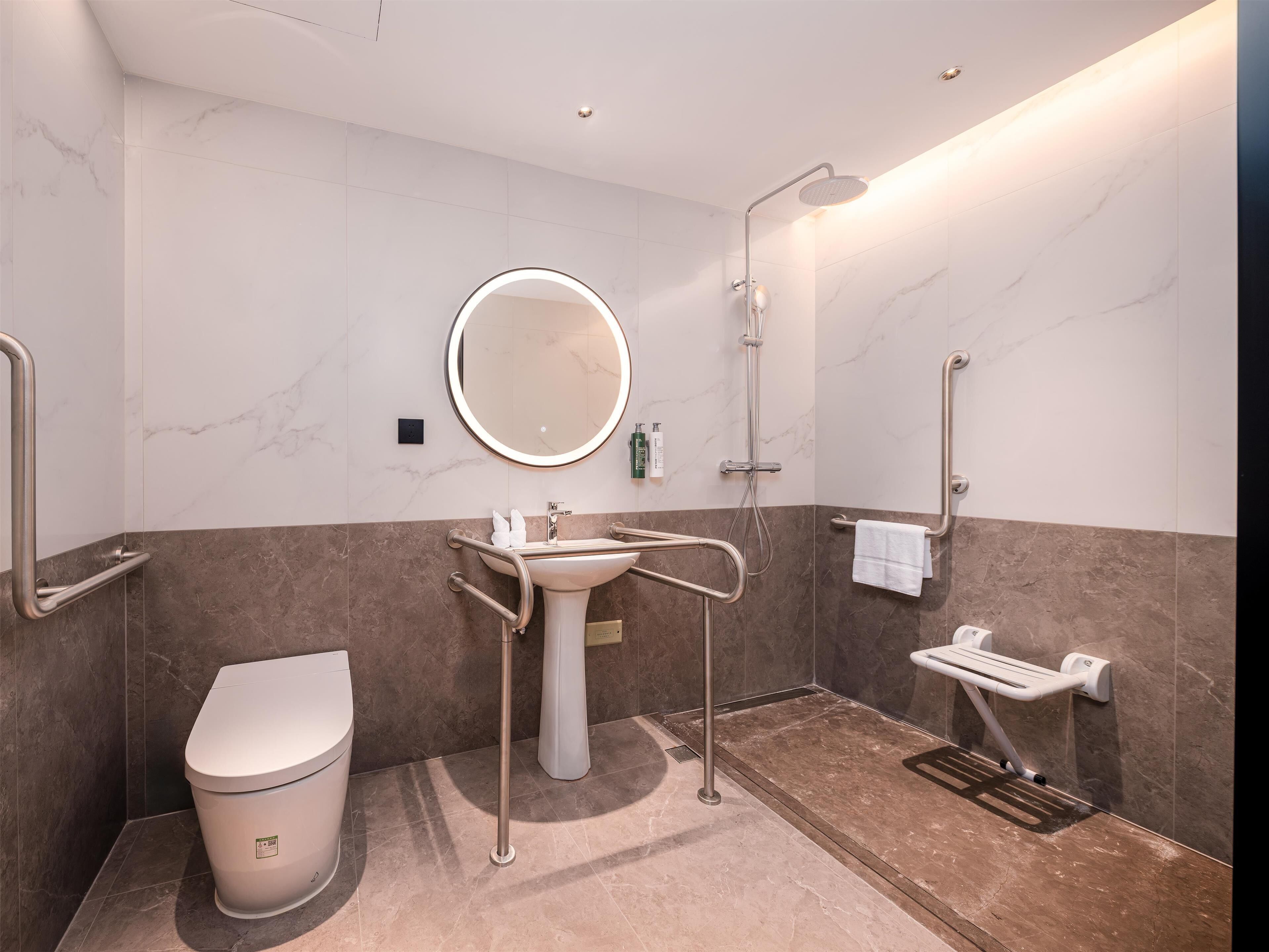 A modern bathroom with a toilet, sink, and shower.