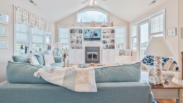 A spacious living room with a high ceiling, a fireplace, and a television. - Spacious 4BR Home near Cape May Beach | Sleeps 10! (Cape May)
