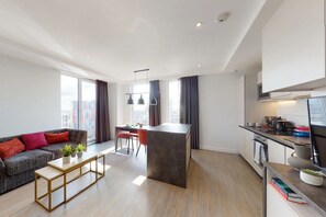 A modern apartment with a dining area, kitchen, and living space. - City Club - Campus Accommodation (Coventry)